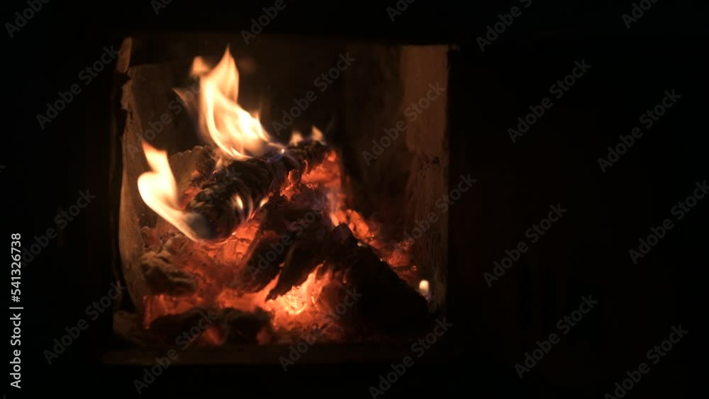Video with flames and sparks rising from wood and coal burning in a stove. Video with flames and sparks rising from wood and coal burning in a stove.