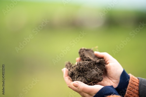 girl holding a soil sample on a farm in Australia