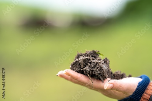 girl holding a soil sample on a farm in Australia