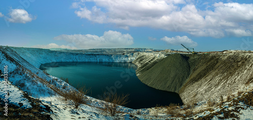 Backfilling and reclamation of a flooded iron ore quarry