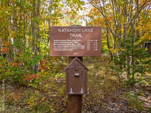 Katahdin Lake Trail sign includes nearby hiking trails and distances in early fall