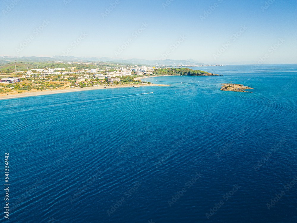 Bird's eye perspective of calm vivid blue Turkish seawaters and sandy beach near the town of Ocurcalar. Popular summer holidays destinations. High quality photo