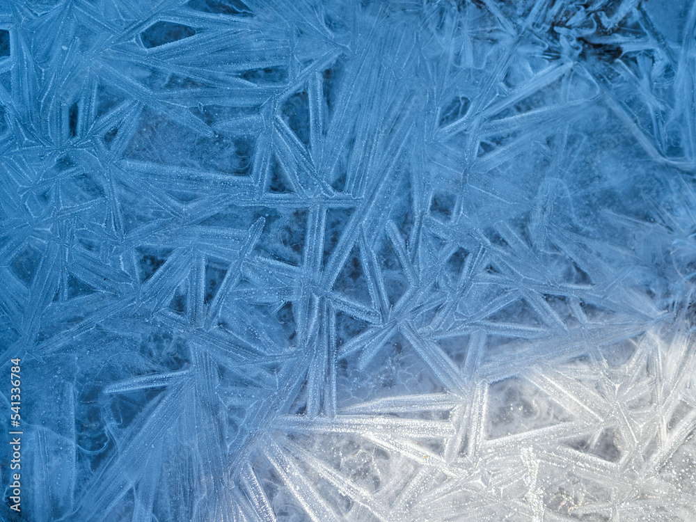 Texture of ice - close-up of ice texture in shades of blue, soft light Texture of ice - close-up of ice texture in shades of blue, soft light