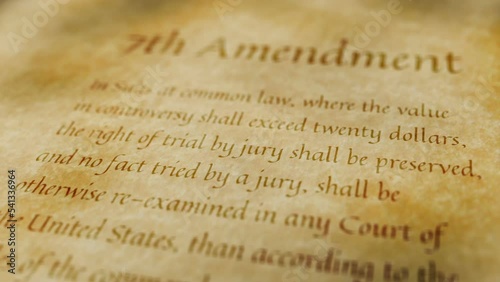 Scrolling text on an old paper background of the contents of the 7th amendment to the United States Constitution that guarantees a trial by jury for civil claims.