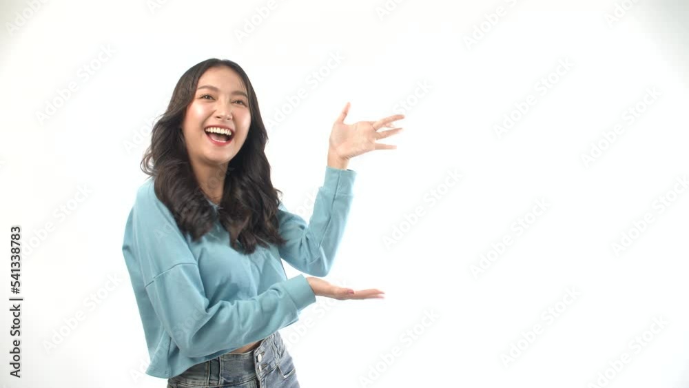 Excited Asian woman surprised wow sale product on empty over white background. Advertisement positive cheerful young girl using hand presenting to copy space shocked amazed happy dance over isolated. Excited Asian woman surprised wow sale product on empty over white background. Advertisement positive cheerful young girl using hand presenting to copy space shocked amazed happy dance over isolated.