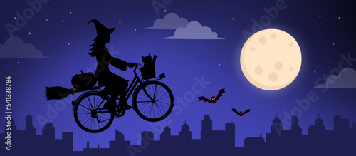 Valokuva Scary witch riding a bicycle and flying