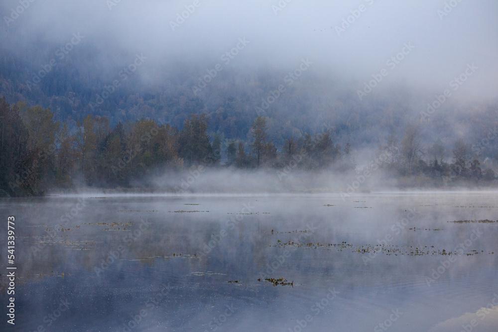 Lake looks serene on a foggy October morning