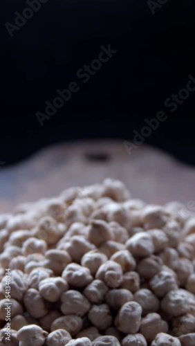raw chickpeas on a rustic wooden board