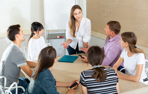 Confident young businesswoman presenting new business project to partners in modern office..