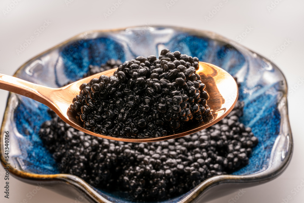 Luxury Black caviar in golden spoon, Texture of expensive luxury caviar. Food concept. Luxury Black caviar in golden spoon, Texture of expensive luxury caviar. Food concept.