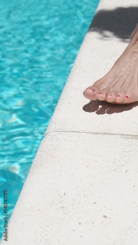woman legs walking towards pool a sunny day	