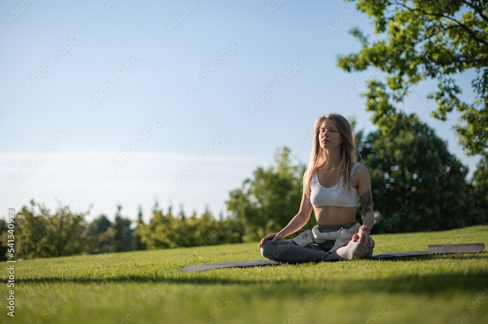 Girl practice yoga meditation outdoor in park Girl practice yoga meditation outdoor in park