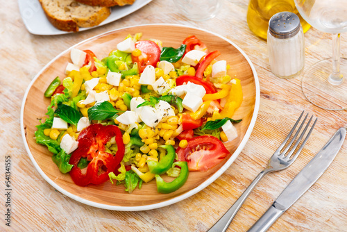 Delicious light vegetable salad of tomatoes, canned corn, pepper and Feta cheese