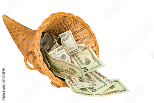 Isolated cornucopia filled with overflowing cash photo
