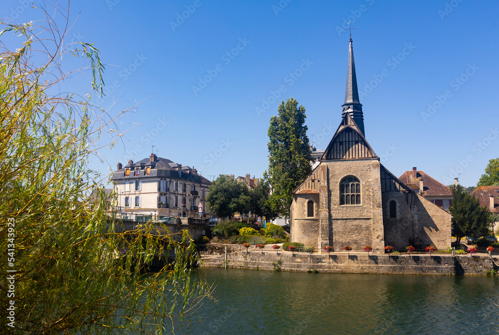 Scenic view of medieval catholic church of Saint-Maurice on bank of Yonne river in small French town of Sens on sunny summer day
