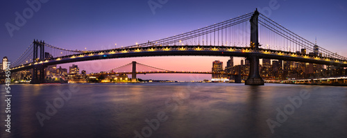 Manhattan Bridge and Brooklyn Bridge and East River in evening. View of DUMBO in Brooklyn and Lower Manhattan. New York City