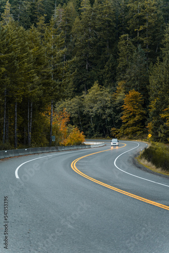 A car driving through a windy road in fall