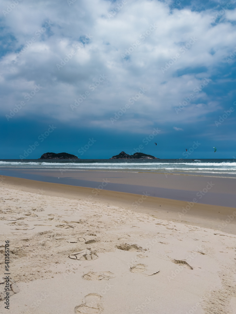 Barra da Tijuca beach, Rio de Janeiro, Brazil. Sunny day with blue sky and some clouds. Windsurfing practice