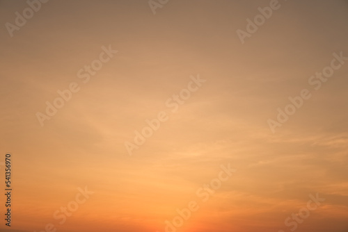 Sunset twilight. Orange sky background. Warm tone sunrise. Nature backdrop. © Win Nondakowit