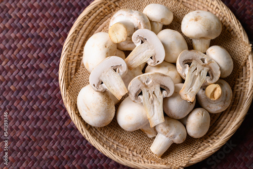 Fresh white champignon mushroom in basket, top view
