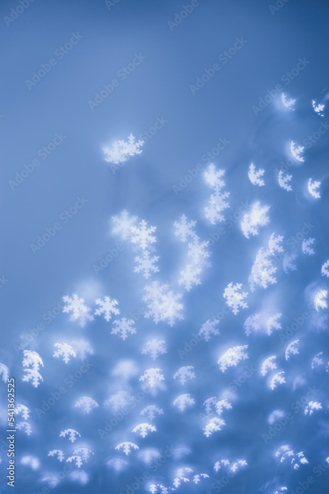 Christmas or New Year abstract magic lights background, white snowflakes bokeh on blue as winter holiday backdrop. Xmas mood aesthetic photo, blurred effect, celebration illumination Christmas or New Year abstract magic lights background, white snowflakes bokeh on blue as winter holiday backdrop. Xmas mood aesthetic photo, blurred effect, celebration illumination