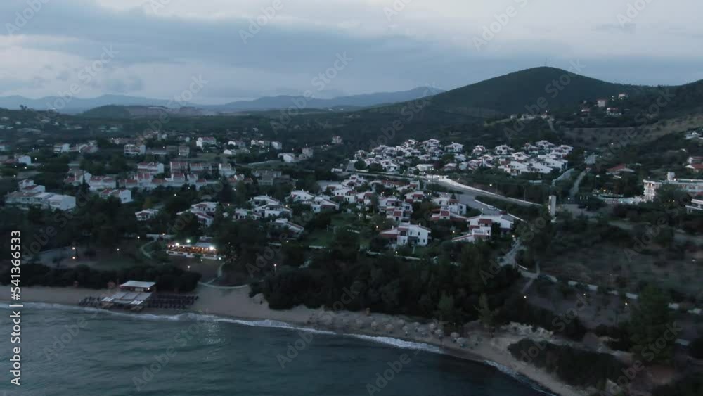 Drone shot over houses and the beach at the evening in Greece Drone shot over houses and the beach at the evening in Greece