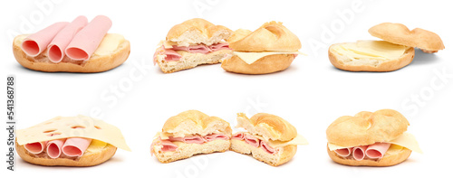 Set of delicious kaiser rolls with butter, ham and cheese isolated on white photo