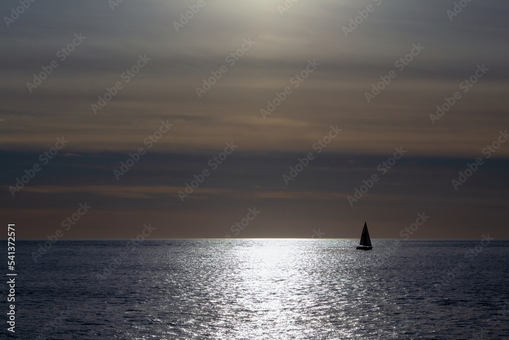 A sail boat in the moonlight.