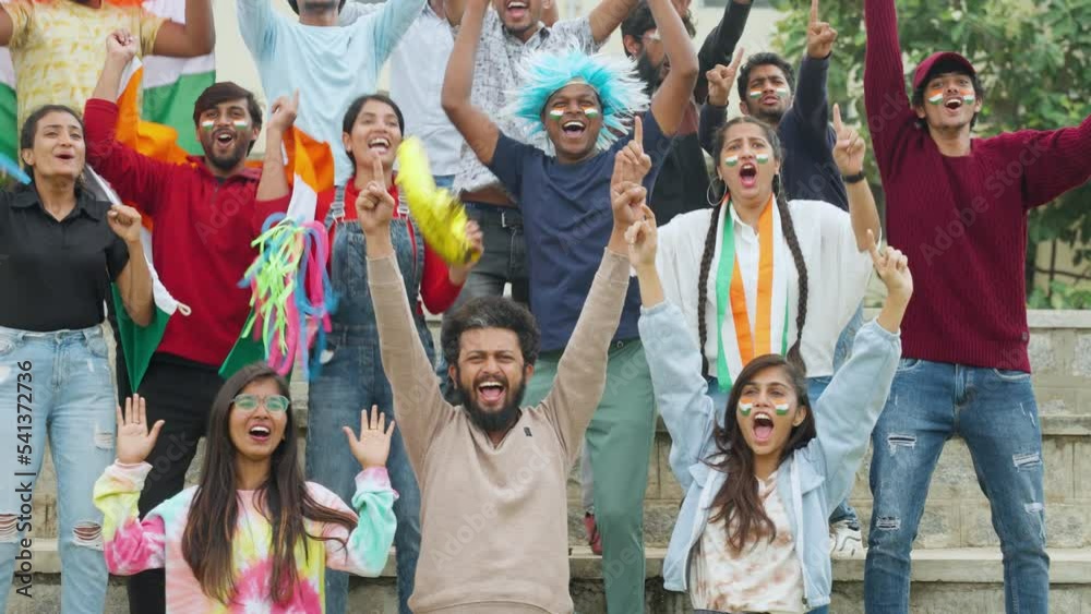 audience at stadium shouting and celebrating the win with indian flags while watching cricket at stadium - concept of tournament, enjoyment and entertainment