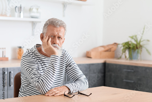 Thoughtful mature man sitti...