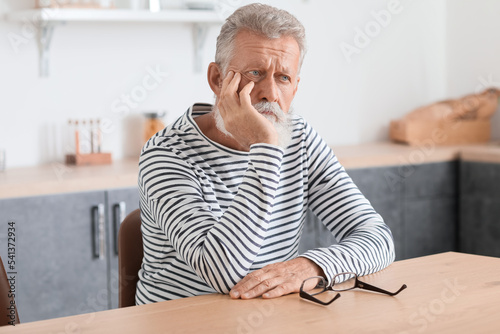 Thoughtful mature man sitti...