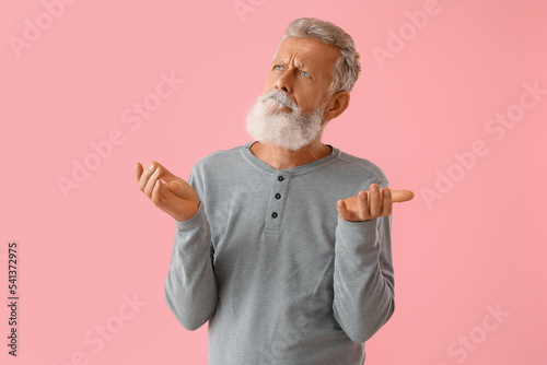 Thoughtful mature man on pi...