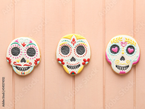 Skull shaped cookies on color wooden background. El Dia de Muertos