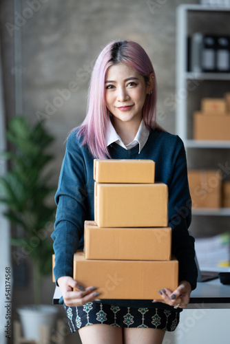 Business digital online SME small business a new startup in the present for an online shop. Happy Young Asian woman have a warehouse used to send a customer Entrepreneur owner SME or freelance concept © PaeGAG
