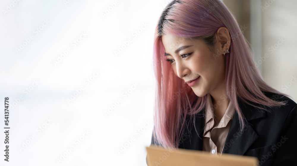Fototapeta premium Happy successful businesswoman relaxing in her chair at the office with a big smile