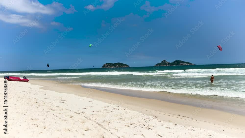 Barra da Tijuca beach, Rio de Janeiro, Brazil. Sunny day with blue sky and some clouds. Windsurfing practice. Barra da Tijuca beach, Rio de Janeiro, Brazil. Sunny day with blue sky and some clouds. Windsurfing practice.