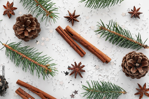 Fototapeta Naklejka Na Ścianę i Meble -  Composition with fir branches, pine cones and spices on white background