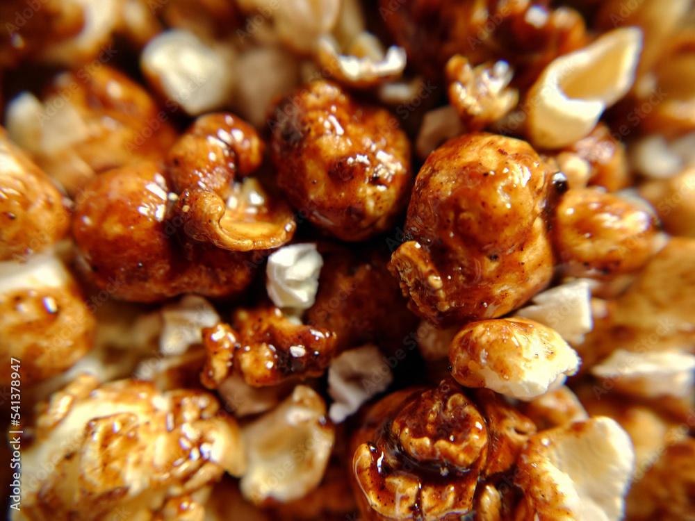 A handful of sweet popcorn with caramel close-up A handful of sweet popcorn with caramel close-up