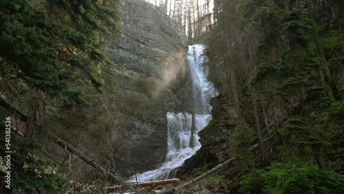 Waterfall with mist and light shining through, early in the morning in Montana photo