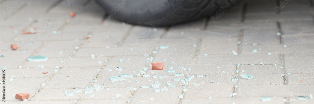 Automobile tyre and pieces of broken glass, car break in, traces of crime, car accident Automobile tyre and pieces of broken glass, car break in, traces of crime, car accident