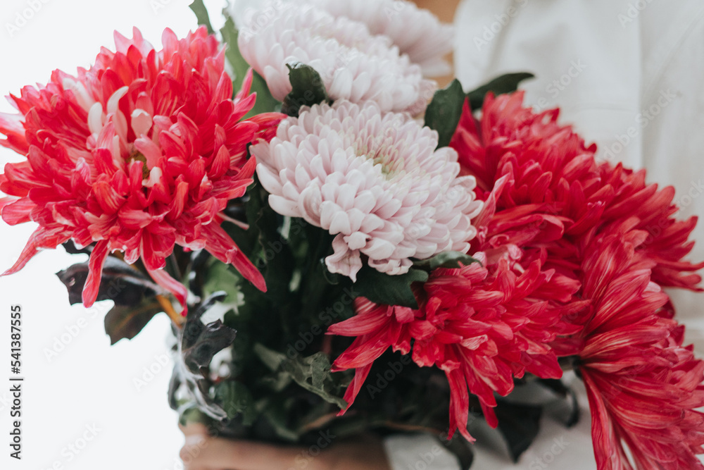 middle-aged woman with a bouquet of chrysanthemum flowers middle-aged woman with a bouquet of chrysanthemum flowers