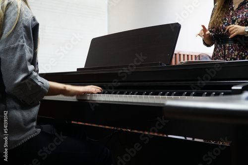 woman learning to play piano