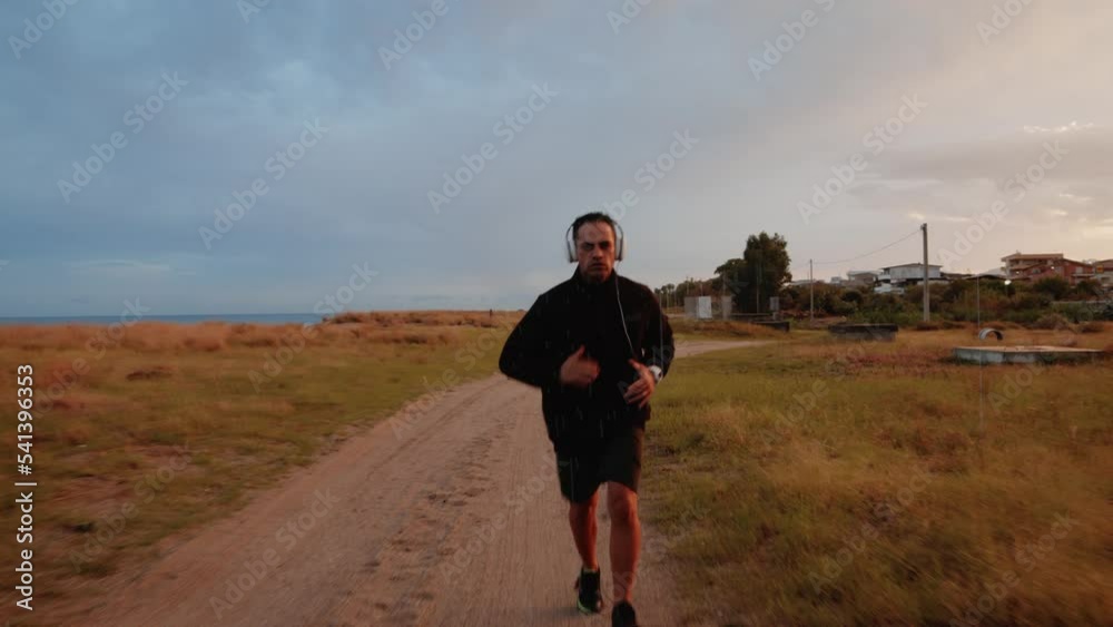 Man running during rain day outdoor in dirty street