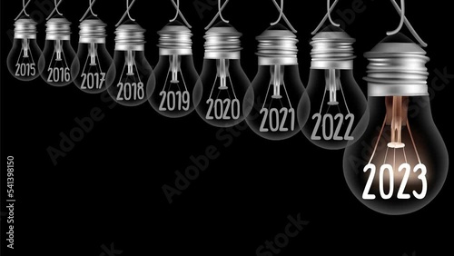 Shining light bulb with New Year 2023 and group of dark light bulbs in a row going from 2015 to 2022 isolated on black background. High quality 4k video.