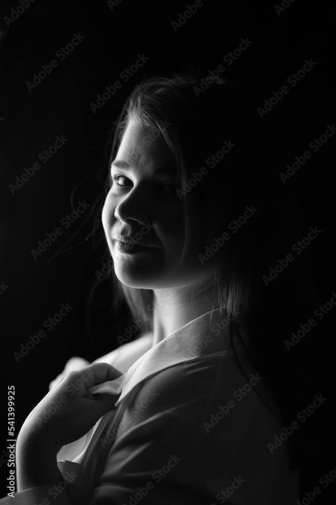 Beautiful girl in the dark, black and white photo. Vertical Orientation