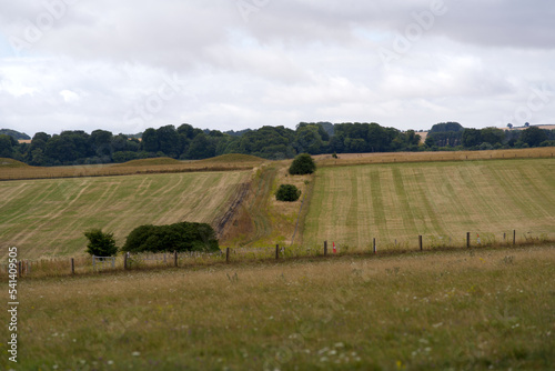 Beautiful rural landscape with agriculture fields at Salisbury Plain in Wiltshire on a cloudy summer day. Photo taken August 2nd, 2022, Amesbury, England. photo