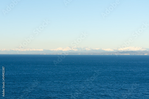view of the sea, alps mountains from the sea at sunset light. Winter landscape. Slovenia