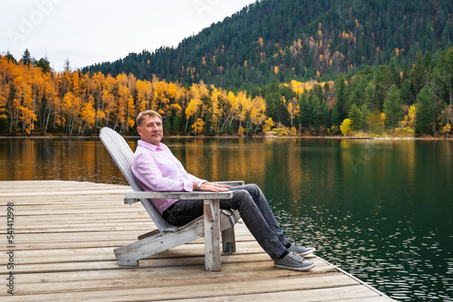 Quadro su tela Man resting in Comfortable wooden sun lounger Adirondack, Westport against of co