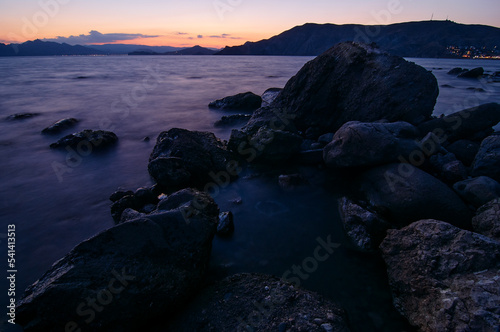 Big rocks and stones at the sea beach on daybreak.