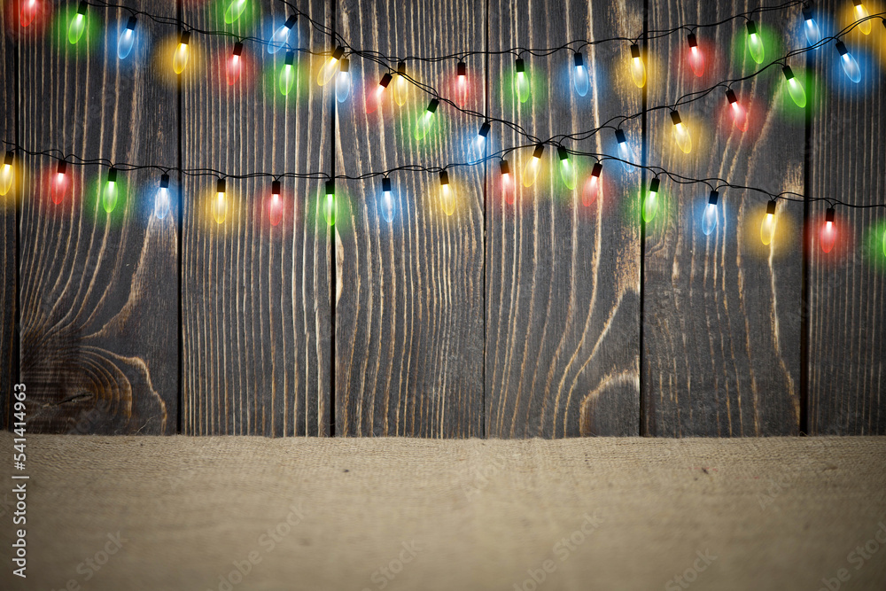 Bright Christmas Lights. Colorful Christmas lights on wood background